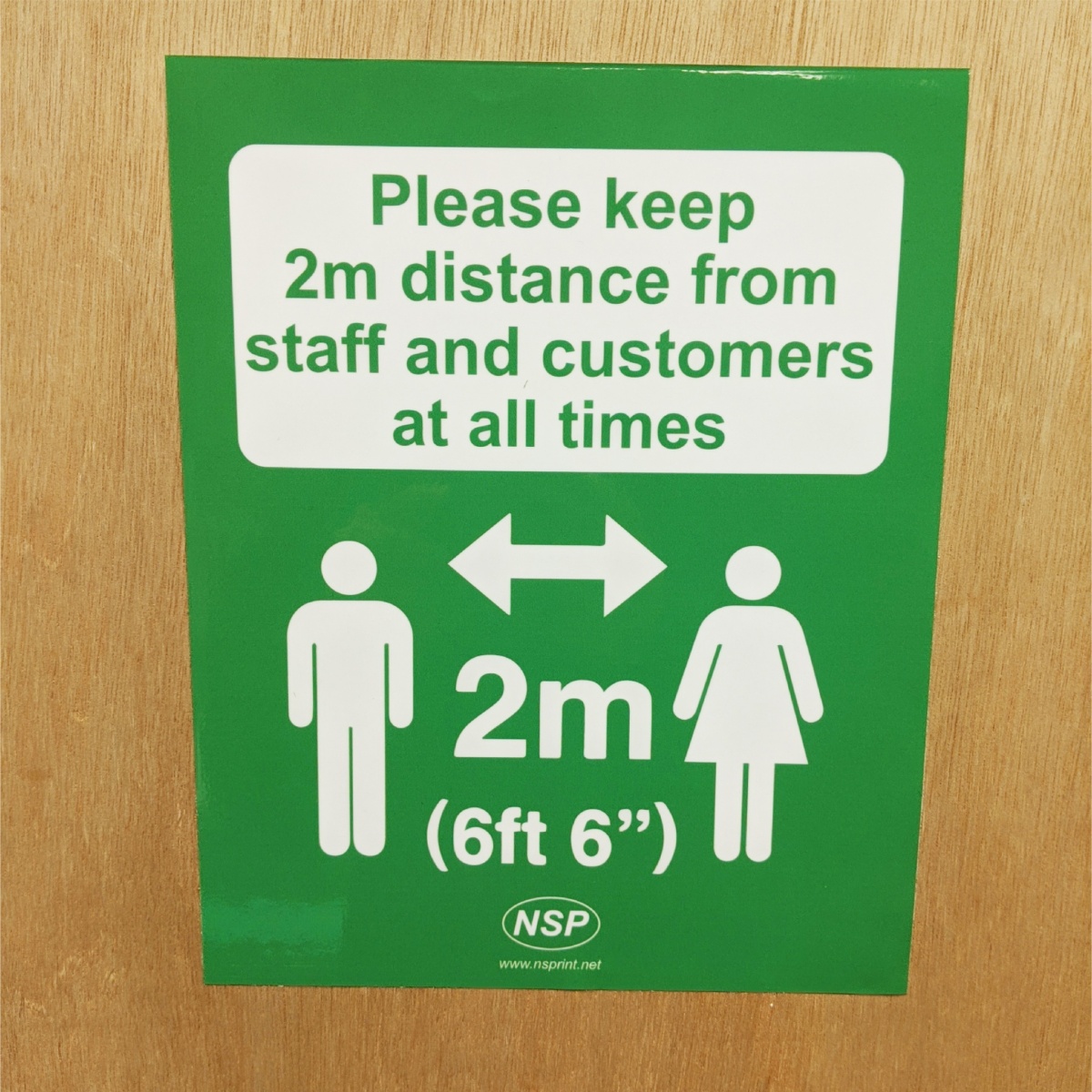green stickers advising people of social distancing rules in force