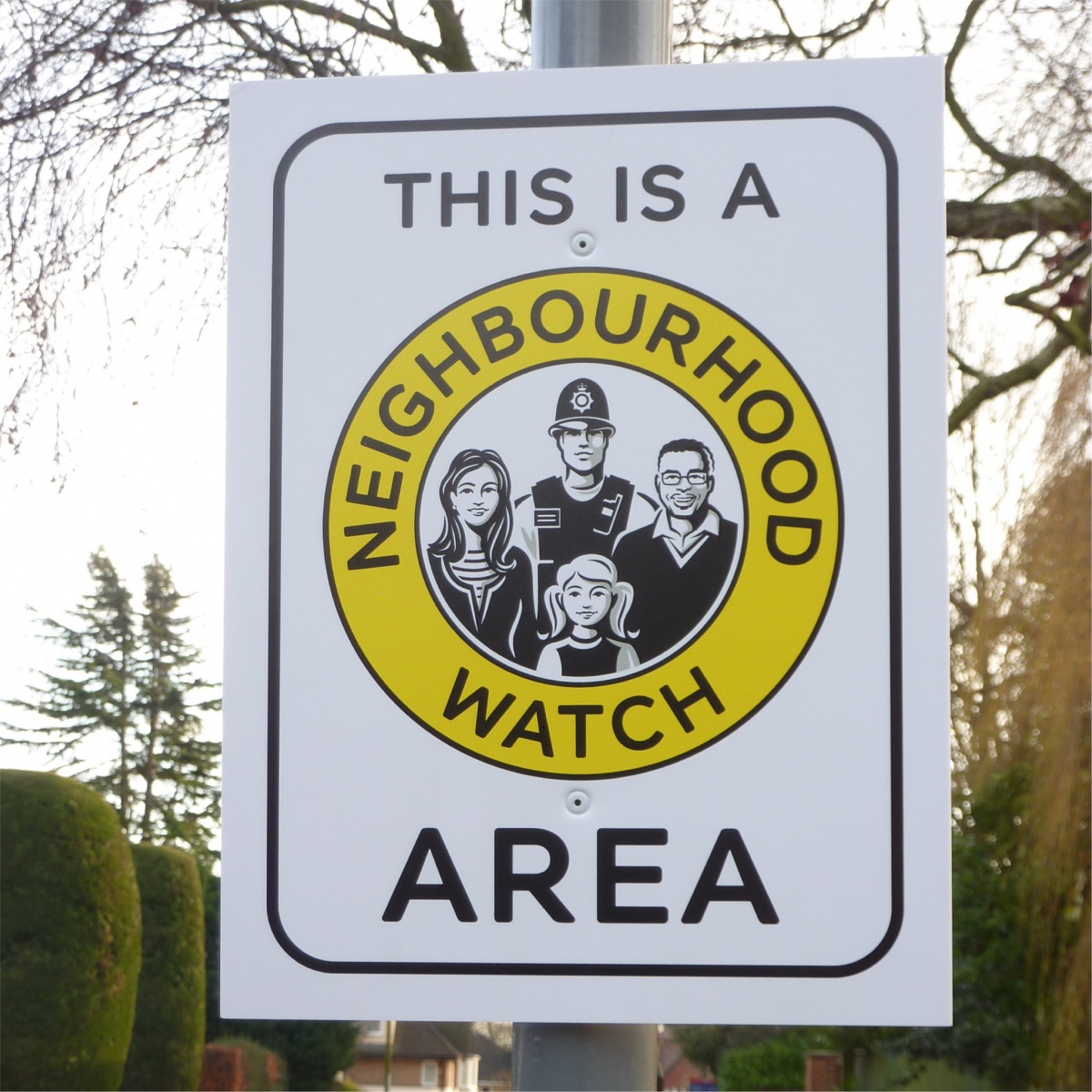 this is a home watch area sign mounted to a lamppost