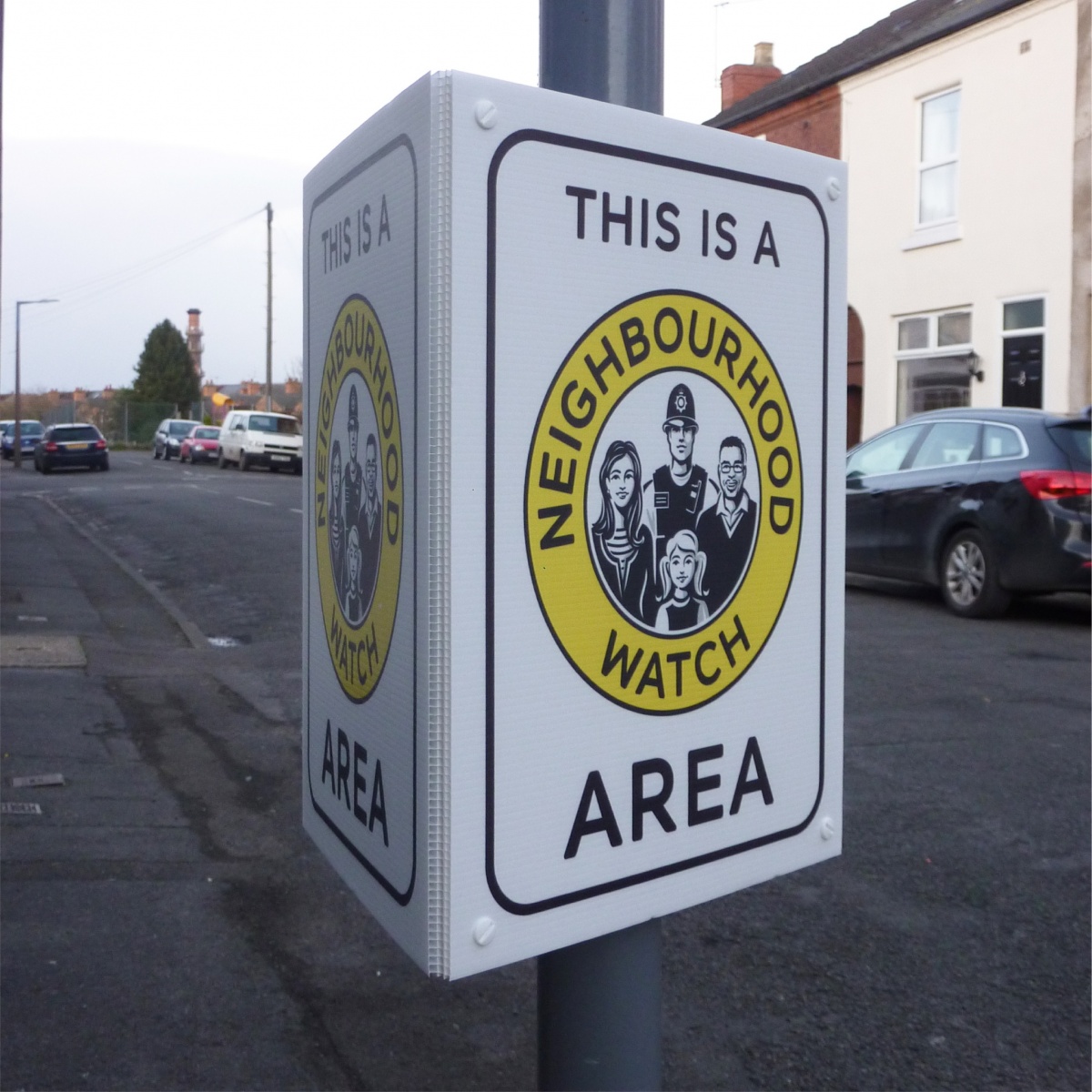 tri-ad neighbourhood watch sign mounted to a lamppost